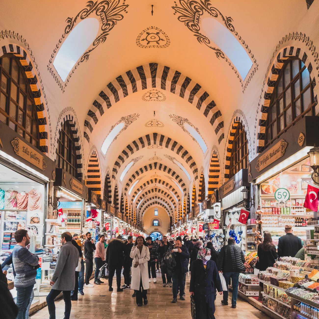 Explore the vibrant atmosphere of Istanbul's Egyptian Bazaar with its ornate architecture and diverse vendors.