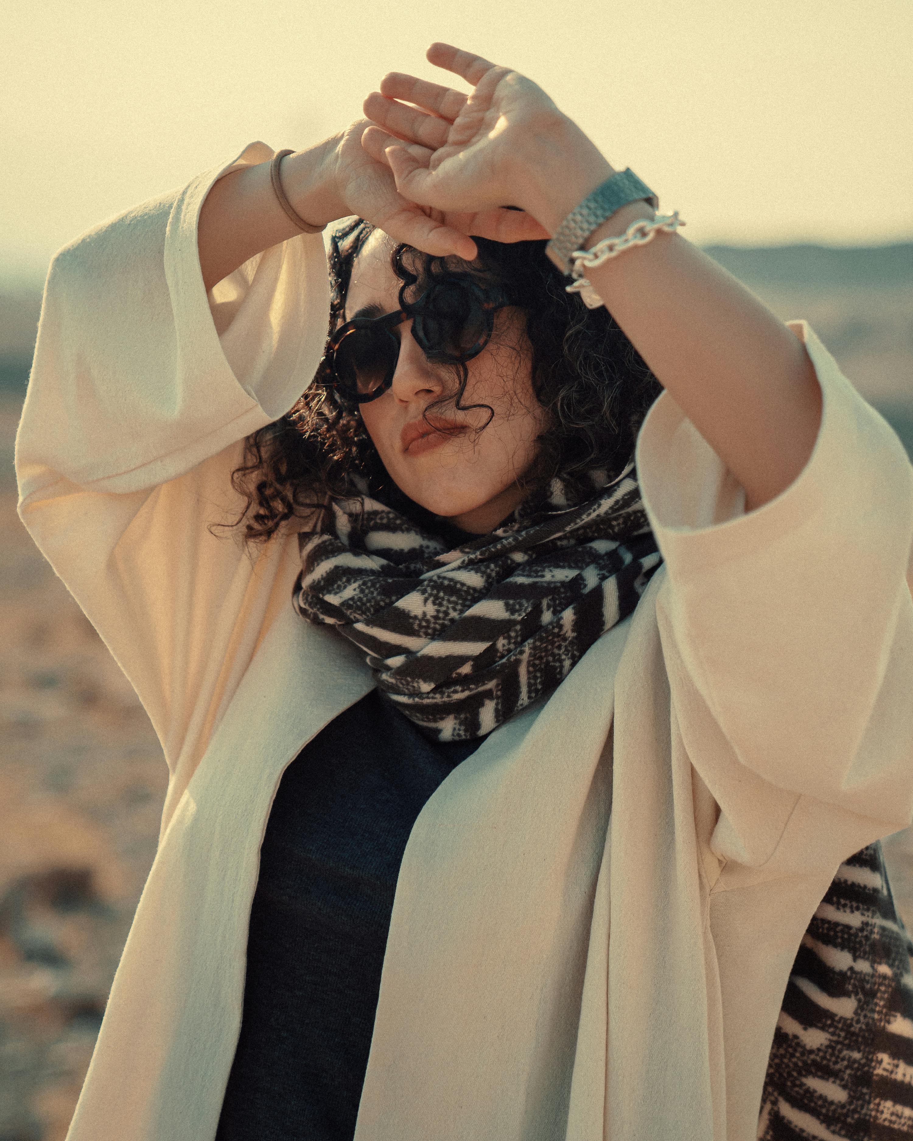 a woman white dress in the desert light of curly hair