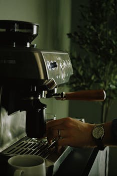 A barista operates an espresso machine to brew a fresh cup of coffee.