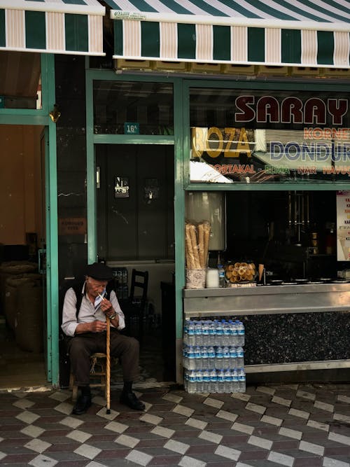 Man Sitting by Ice Cream Store in Turkey