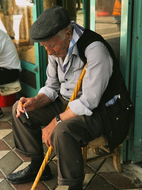 Elderly Man Sitting with Cigarette