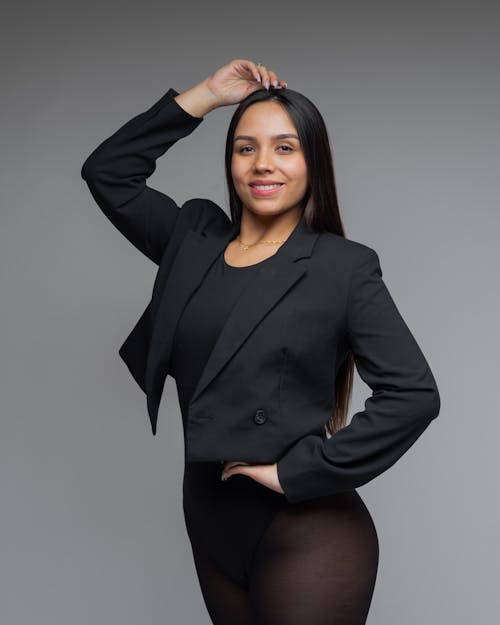 Smiling Brunette in Bodysuit and Blazer