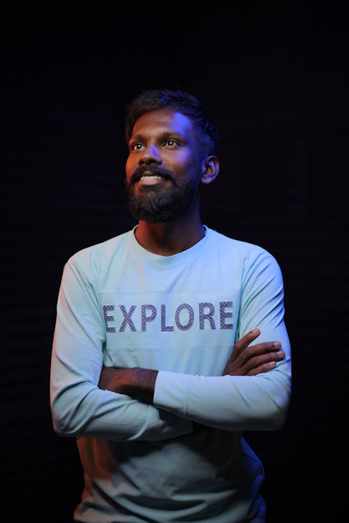 Smiling Man Standing with Arms Crossed