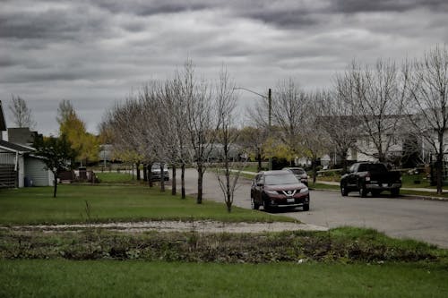 Fotos de stock gratuitas de calle vacía, coche aparcado, nubes