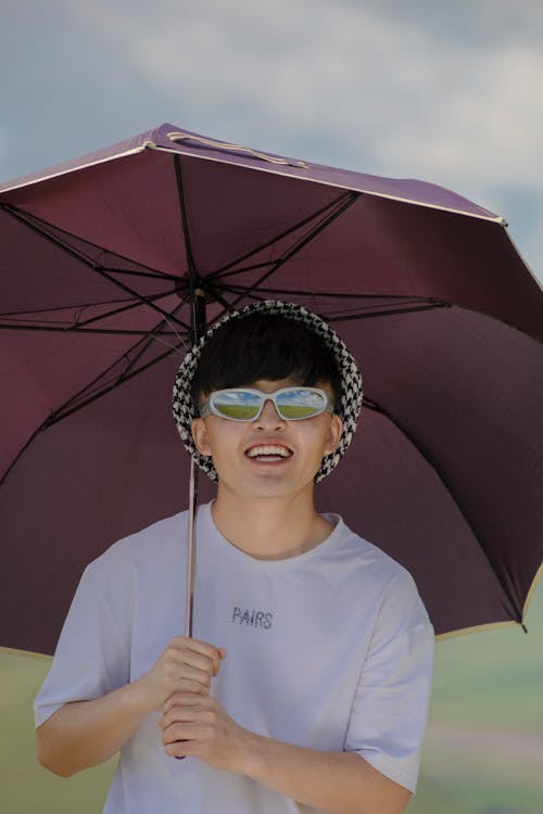 Smiling Man in Sunglasses and with Umbrella