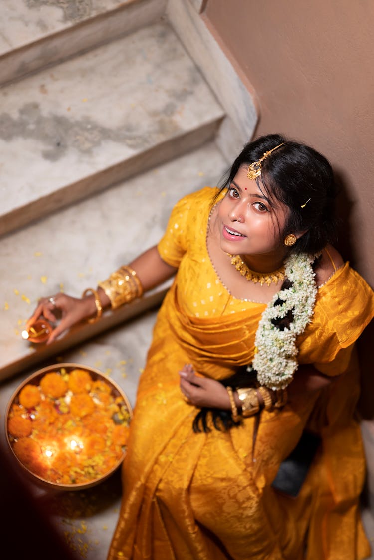 Woman In Traditional Dress Sitting On Stairs