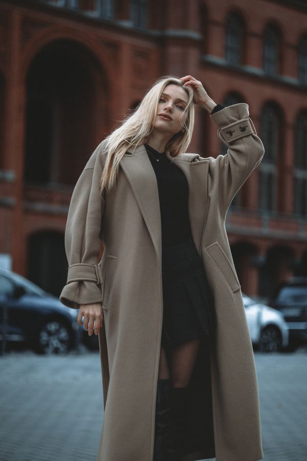Brown boots with puffer vest and thermal top
