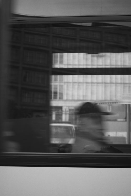 Free Blurred motion of a man reflected in a bus window in Berlin, capturing urban essence. Stock Photo