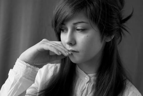 Black and White Photo of a Sad Young Woman 