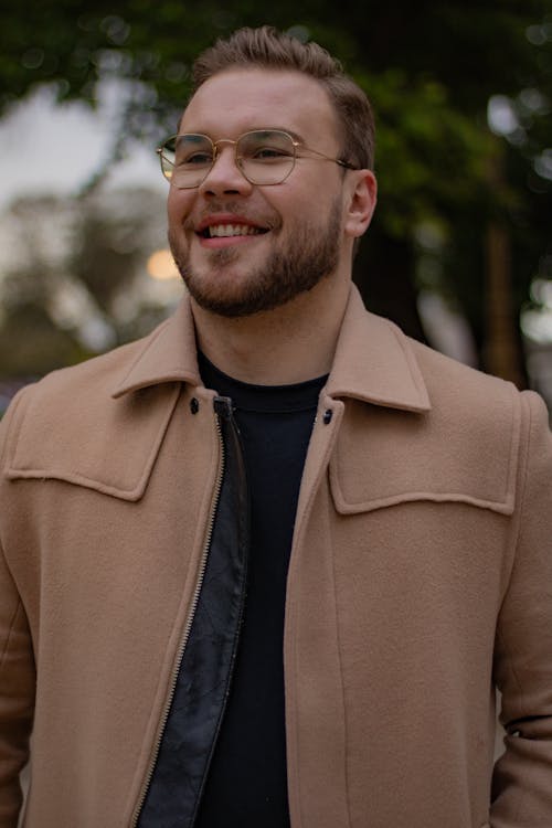 Smiling Man in Eyeglasses and Beige Woolen Jacket