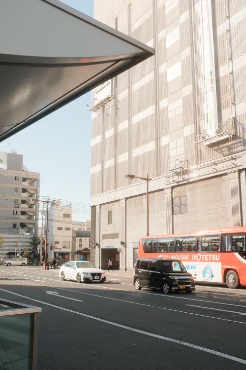 Free City street view featuring buses and modern buildings on a sunny day. Stock Photo
