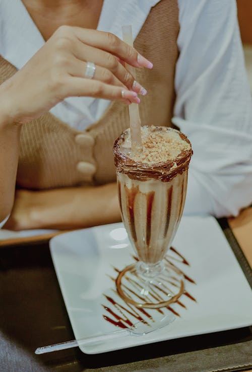 Woman Hand Holding Sweet Drink with Chocolate