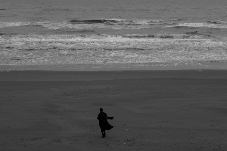 Person Standing Alone On Beach