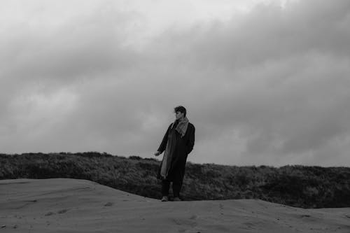 Black and White Photo of a Man in Elegant Coat and Long Scarf