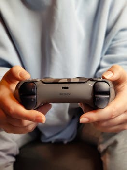 Close-up of hands holding a Sony game controller, ideal for gaming-themed content.