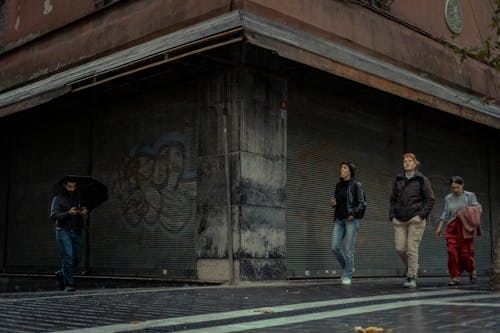 Pedestrians Walking on the Sidewalk in City 