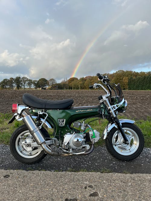 A Honda Dax Motorcycle on the Road in the Countryside 