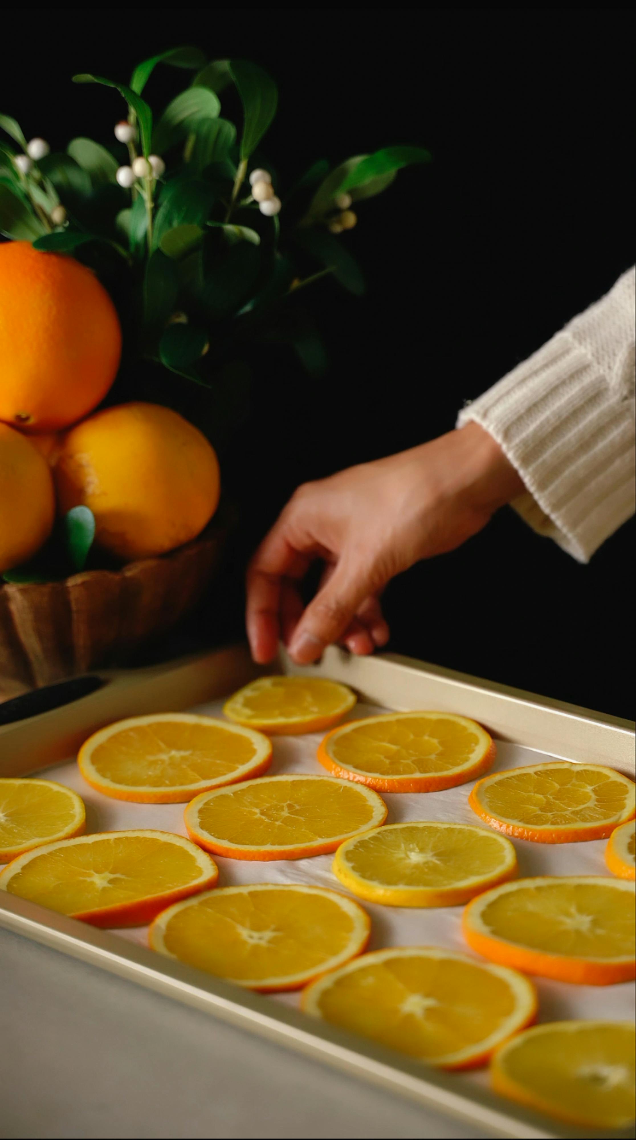 Woman Putting Oranges on a Tray · Free Stock Photo