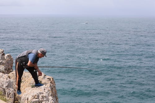 Fotos de stock gratuitas de cerca del mar, pescador