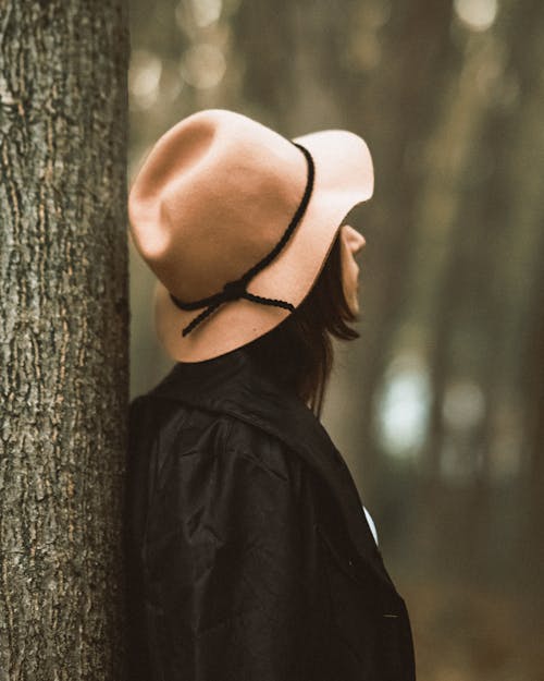 Woman Wearing a Hat in a Forest