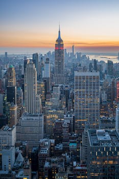 Breathtaking cityscape view of New York with Empire State Building at sunset.