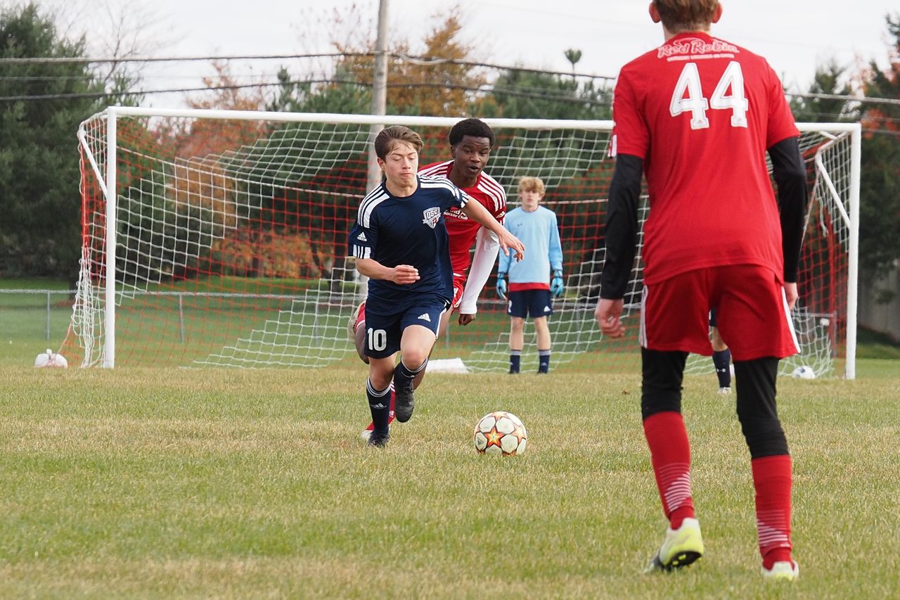 dynamic action shot of teenage soccer game capturing intense competiti