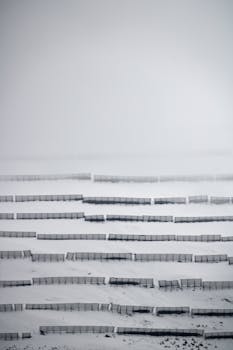 Snow-covered slopes with fences creating patterns in Hintertux, Austria.