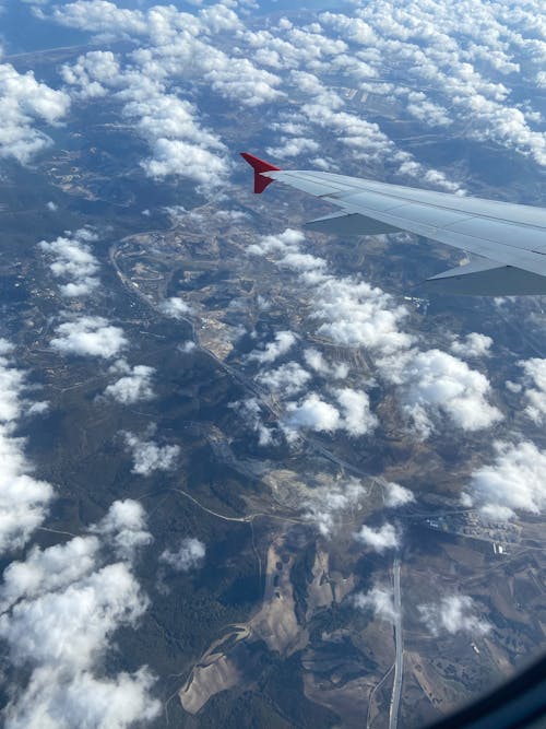 View of Clouds and Land from an Airplane 