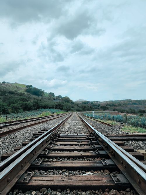 Free Wide view of railway tracks through rural landscape in Tequila, Jalisco, Mexico. Stock Photo