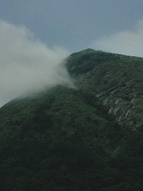 View of a Large Mountain with a Peak in Clouds 