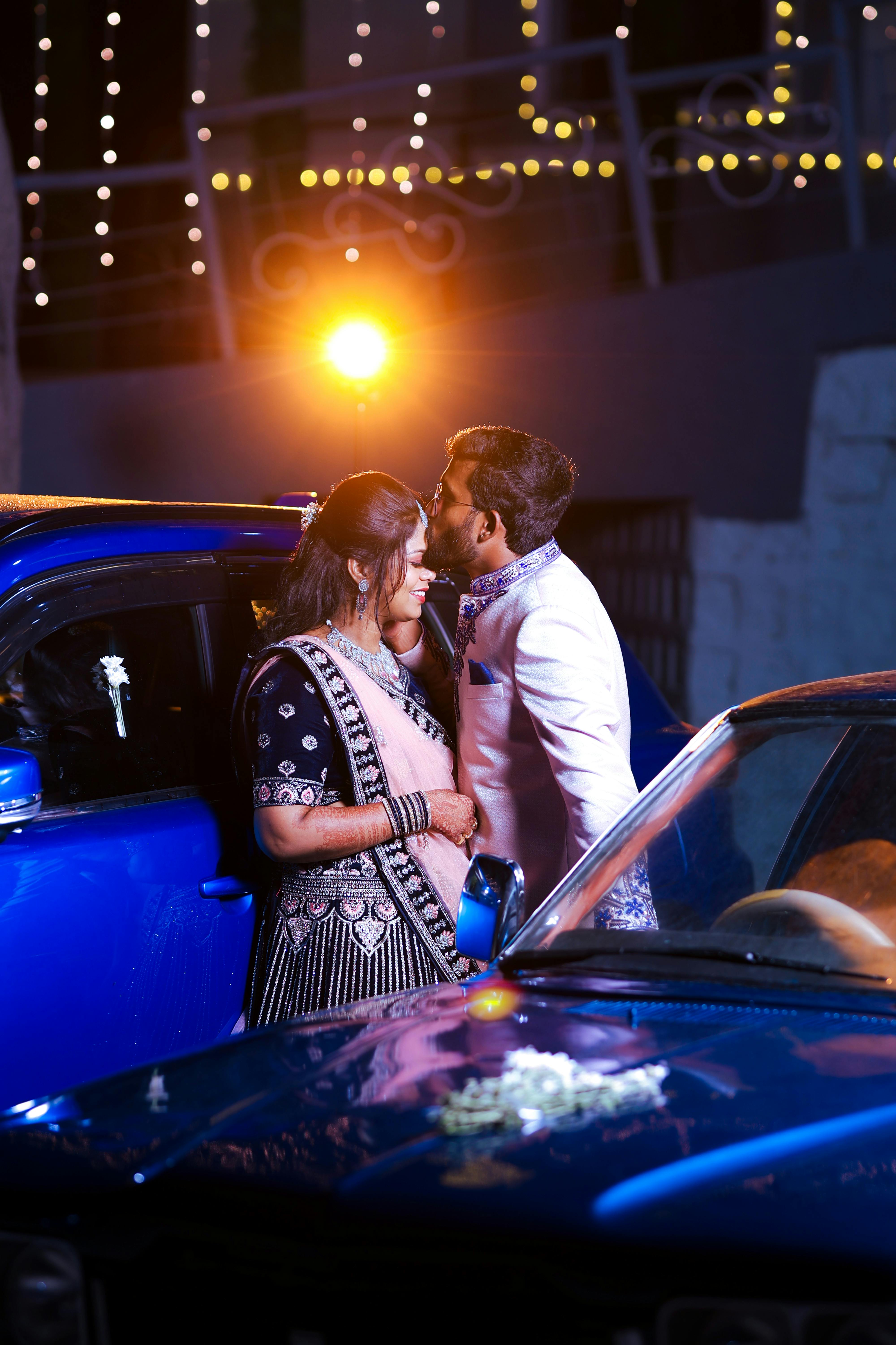 Indian Couple Kissing Among Cars · Free Stock Photo