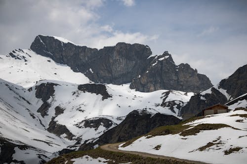 A mountain road with snow covered mountains in the background