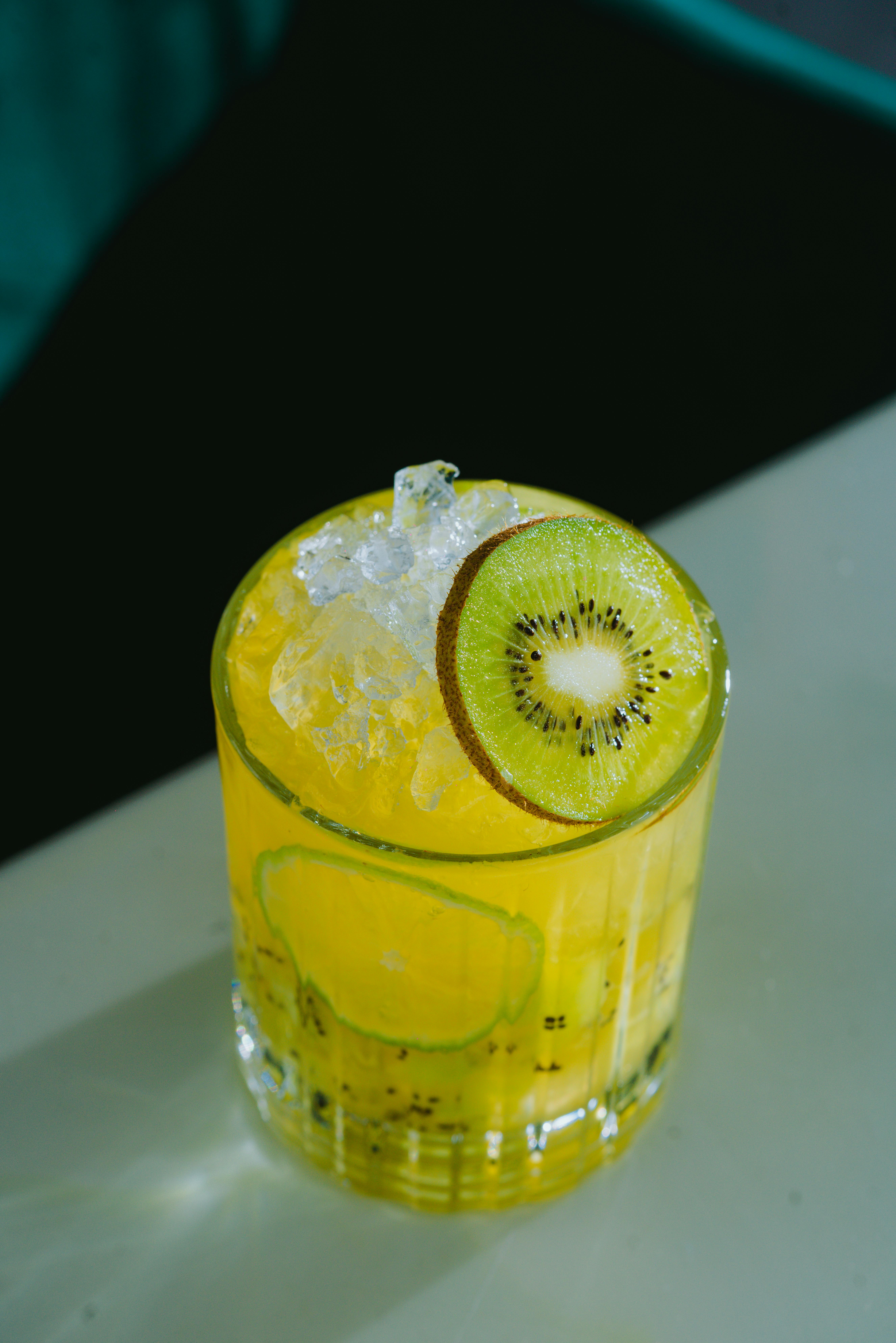 Free A Yellow Cocktail with a Slice of Kiwi Stock Photo
