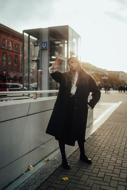 Free Fashionable woman in coat posing in sunny autumn city street, urban style. Stock Photo