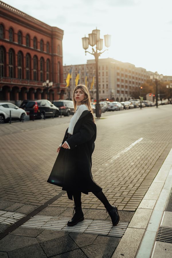 Woman in long black wool coat over red dress