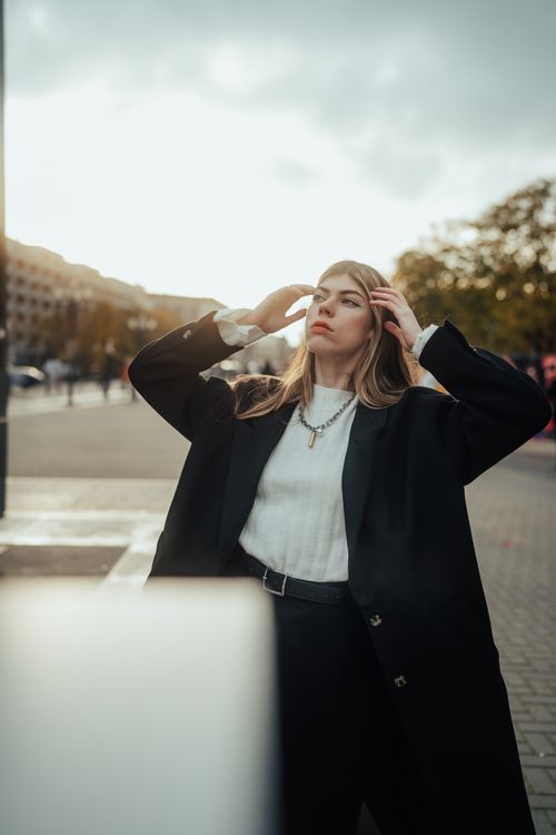 Free Fashionable woman poses in city wearing stylish coat on a cool autumn day. Stock Photo