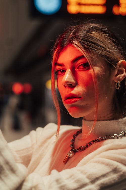 Blonde Woman Wearing Sweater in Red Light 