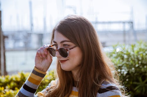 Photo of Woman Holding Her Sunglasses