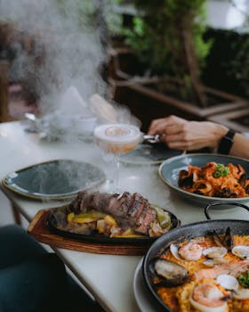 Indulge in a luxurious dining experience with sizzling steaks and seafood pasta at a gourmet restaurant.