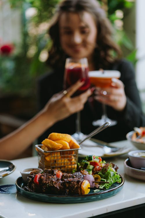 People Eating and Drinking in a Restaurant 