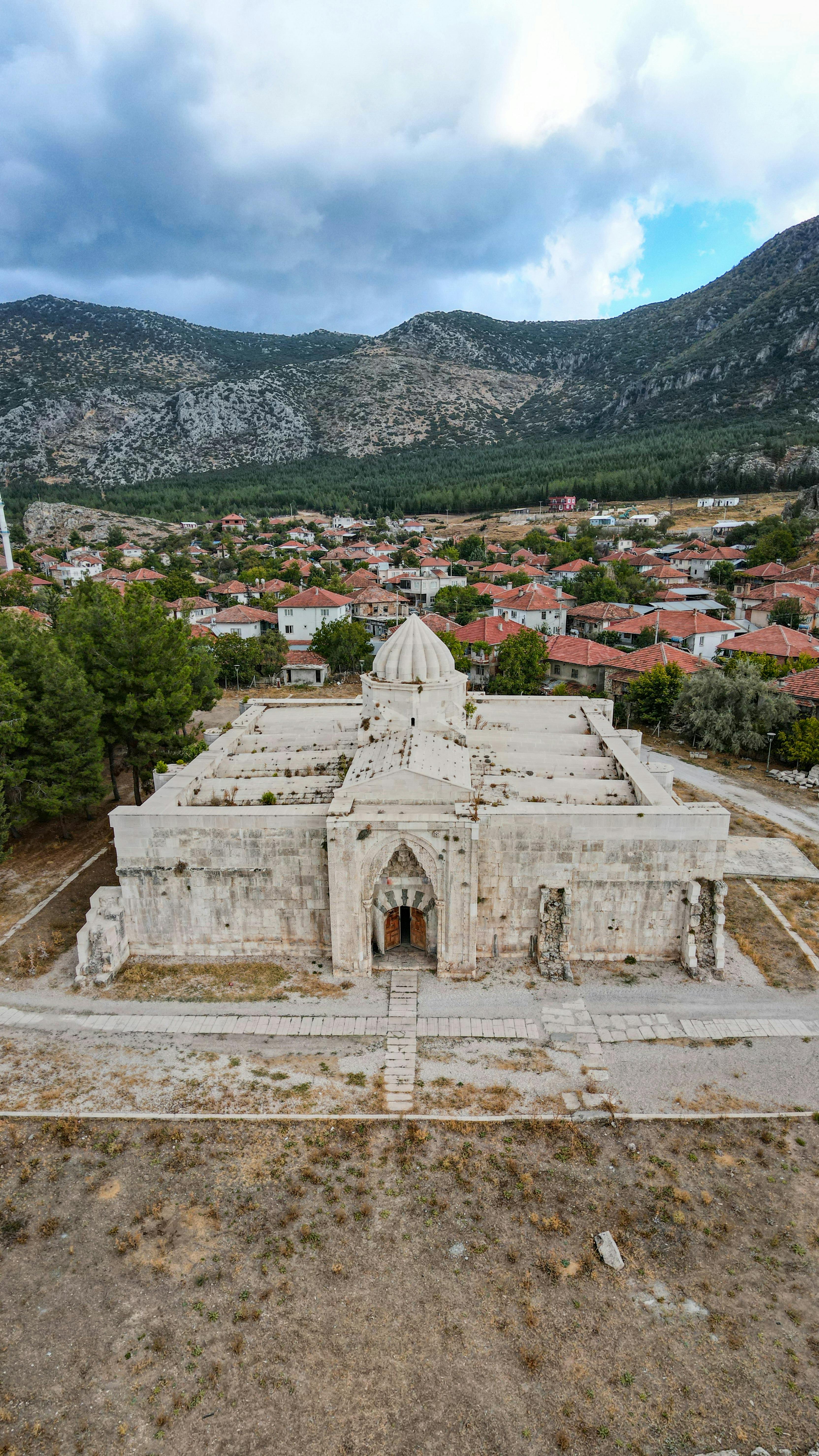 Explore the ancient Susuz Han caravanserai set against the rural Turkish countryside.