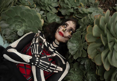 Woman Wearing Halloween Costume Among Tropical Plants 