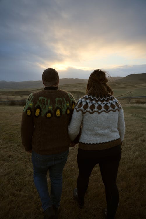 Couple Walking Hand in Hand Through the Hillside Pastures