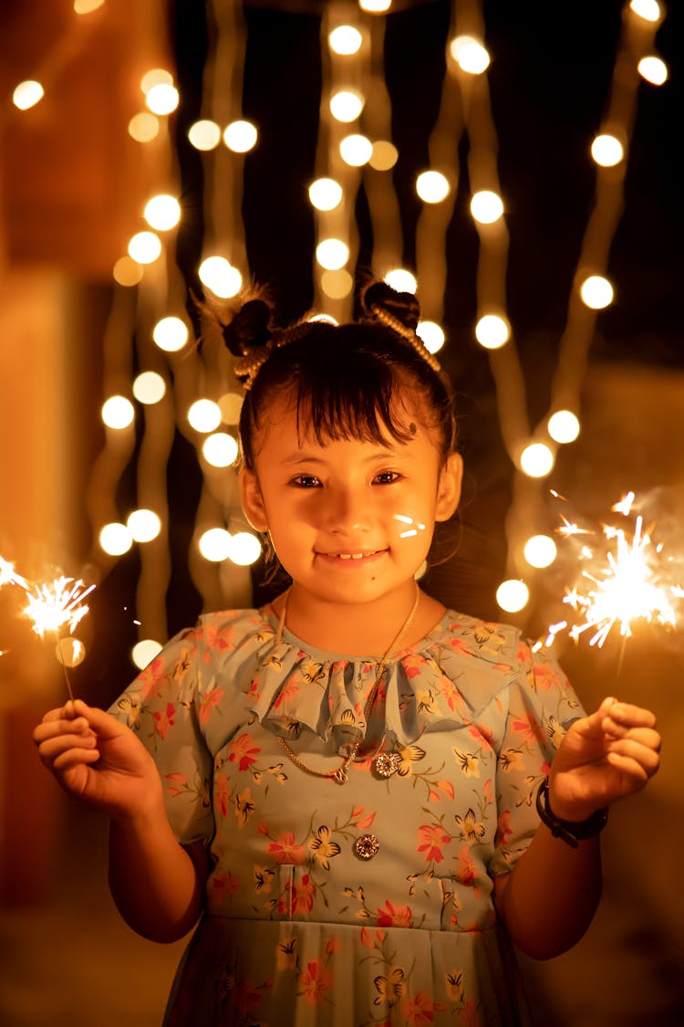 Cute Little Girl In Dress With Fireworks In Hands