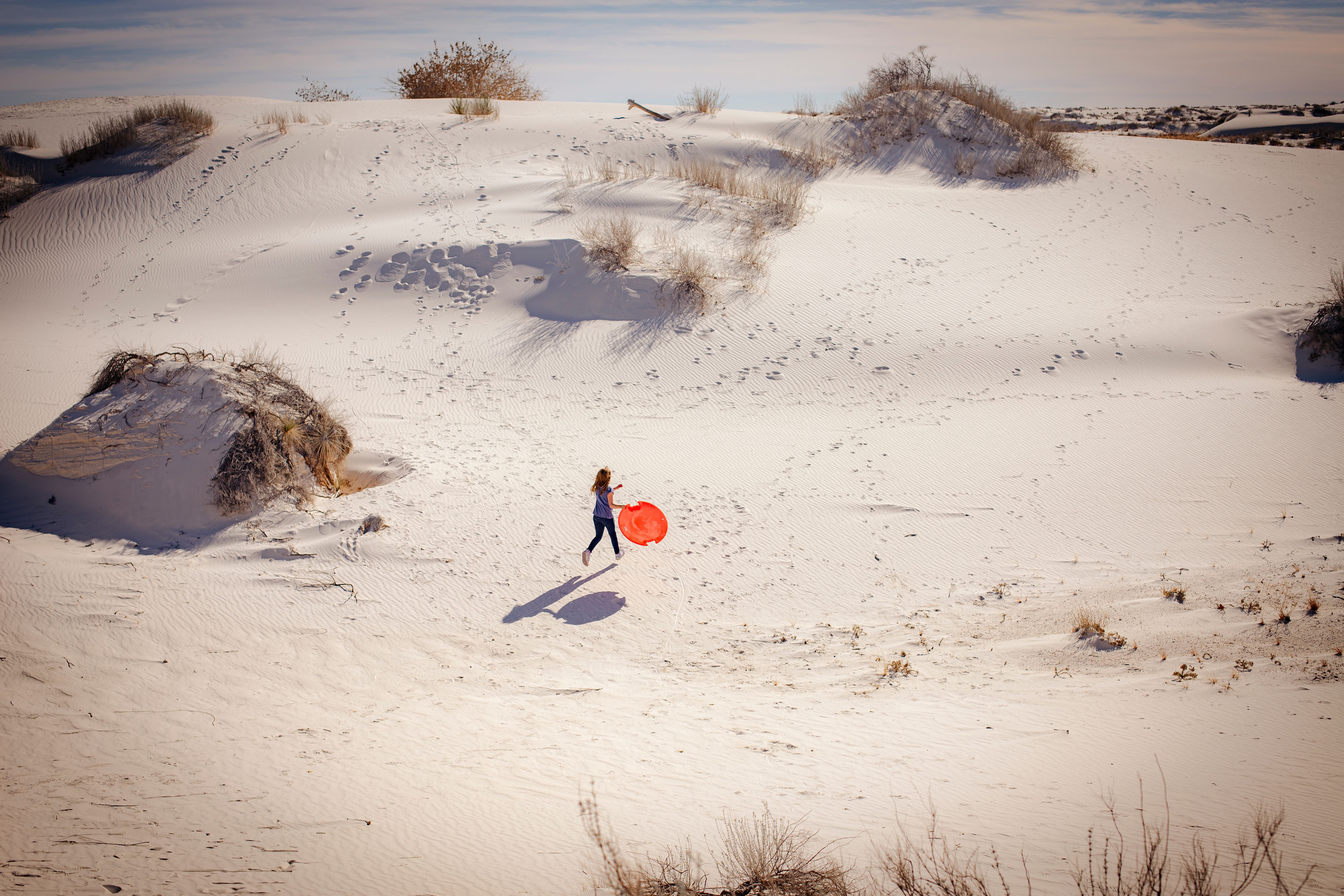 Sledding down a gypsum dune on a plastic saucer