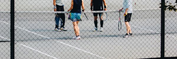 Group of players on a tennis court during a Neighborhood Tennis break camp