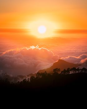 Stunning sunset over mountains with dramatic clouds and vibrant colors, creating a serene and majestic landscape.