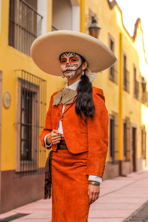 Catrina in a Large Beige Sombrero and a Red Charro Suit