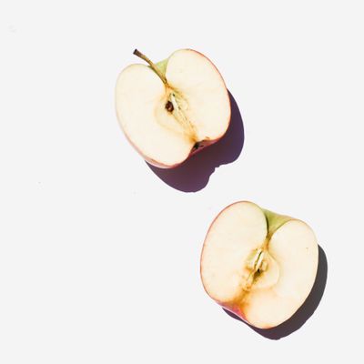 Two apple halves on a pale ground, photo by Studio Naae on Pexels