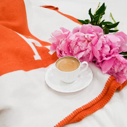 Free A Cup of Coffee and a Bunch of Pink Peonies  Stock Photo